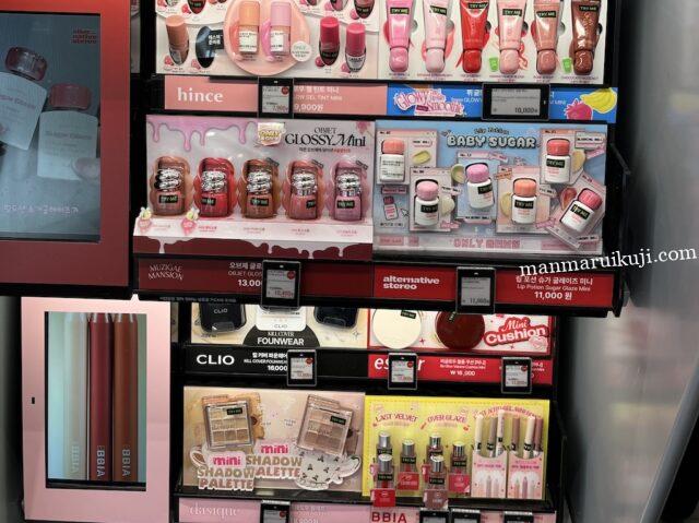 様々な韓国コスメブランドの棚が並ぶメイクコーナー。奥には大きな鏡のあるトレンドコーナーが見えます。